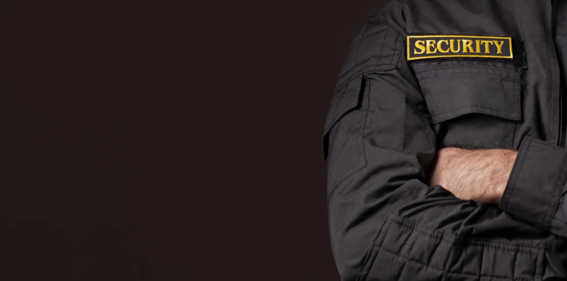Professional security guard wearing a black security uniform symbolising trust, authority, and control